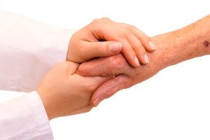 A doctor holding/ shaking an old womans hand.